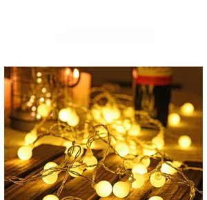 Detail view of warm yellow spherical LED string lights for Christmas tree decoration