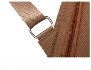 Detail of silver metal strap buckle and brown textured fabric on vintage backpack