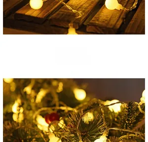 Detail of warm yellow LED globe string lights on vintage wood and Christmas tree