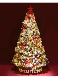 Close-up of 2.1m flocked snow Christmas tree with red bows and warm LED lights