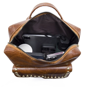 Interior view showing the large capacity of the brown PU leather backpack with essentials