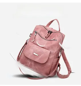 Lightweight pink leather backpack with vintage texture shown with a white feather detail