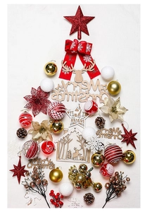 Flat lay of Christmas tree decorations including red balls, pine cones and wooden signs