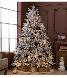 Luxurious snow-flocked Christmas tree with warm LED lights and elegant ornaments