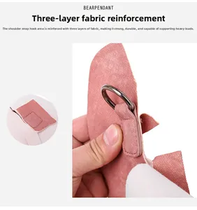 Detail of pink corduroy backpack featuring triple-layer reinforced stitching and D-ring hook