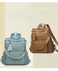 Front view of stylish woven texture backpacks in blue and brown with tassel details