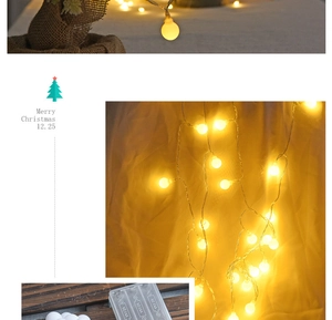 Detail of warm yellow LED globe string lights with transparent AA battery power box
