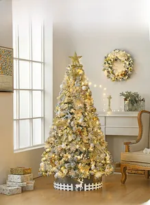 Close-up of 2.1m flocked Christmas tree with warm LED lights and golden decorations