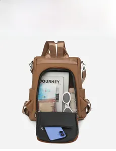 Detail view of brown vintage backpack interior showing large capacity for laptop and books