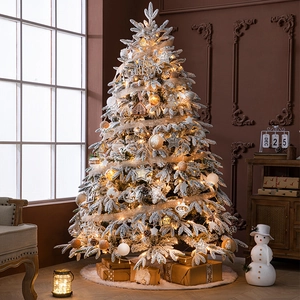 White flocked artificial Christmas tree with warm LED lights and vintage ornaments