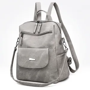 Grey multi-functional faux leather backpack for women with metal accents and dual zippers