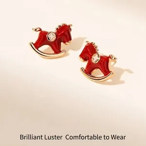 Exquisite gold-plated rocking horse earrings with red enamel and star detail