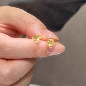 Asymmetric gold horse and coin earrings with vintage hollow design and textured finish