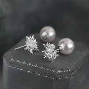 Elegant silver starburst pearl stud earrings with large pinkish-white pearls for women