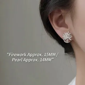 Fireworks shaped silver stud earrings with large white pearl on female model ear