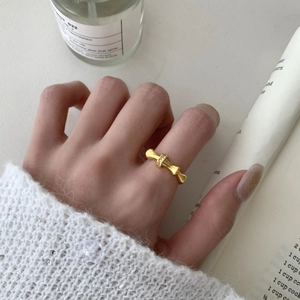 Elegant gold bamboo knot ring with pavé zircon stones worn on index finger