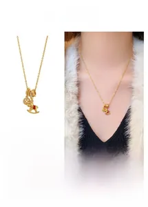 Detail of gold horse pendant necklace with coin charm and micro-inlaid ring in gift box