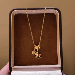 Micro-inlaid horse pendant necklace with coin charm in a velvet jewelry box