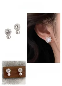 Detailed close-up of French style snowflake pearl earrings with cubic zirconia stones
