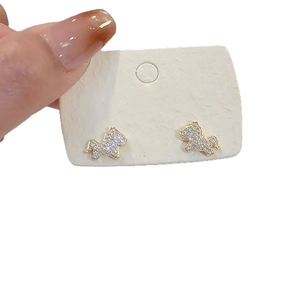 Elegant gold pony stud earrings with white cubic zirconia crystals on display card