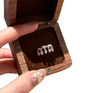 Elegant silver ring with sparkling teardrop tassels presented in a luxury wooden gift box