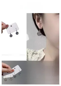 Detailed view of silver and gold circle earrings with sparkling cubic zirconia stones