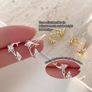 Dual dolphin earrings in gold and silver finish with adjustable three-gear design