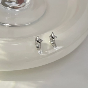 Detailed close-up of silver four-pointed star hoop earrings with round sparkling cubic zirconia