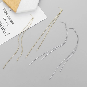 Minimalist long threader earrings in gold and silver finish shown from a 45-degree angle