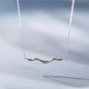Minimalist silver wave necklace with polished curved pendant and slim cross chain