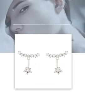 Detailed view of silver star earrings featuring sparkling rhinestones and star pendants