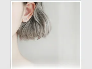 Macro detail of silver star ear crawler with zircon stones on female ear