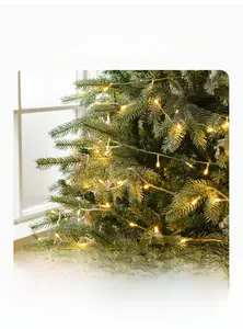 Détail d'un sapin de Noël nordique artificiel avec des LED chaudes et aiguilles denses