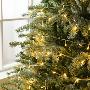 Sapin de Noël luxueux avec pointes enneigées et guirlande LED blanc chaud pour décoration