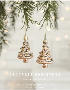 Detail of rose gold Christmas tree ornaments with glitter on pine branches