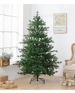 Detail of lush green artificial Christmas tree with sturdy black metal stand for decor