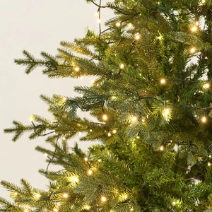 Luxurious 1.8m Christmas tree with warm white LED string lights and dense PE mixed pine needles
