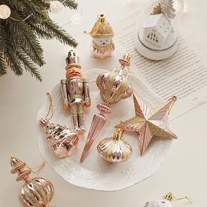 Champagne gold Christmas tree ornaments set with nutcrackers and stars on a white plate