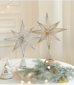 Detail of gold and silver wire Christmas tree star toppers with warm LED lights