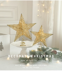 Close-up of golden glittery star tree toppers with spiral bases in a festive setting