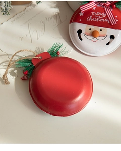 Detail of red painted metal Christmas bells with artificial pine and merry christmas text