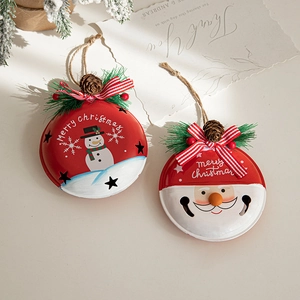 Christmas iron bell ornaments with snowman and Santa patterns, pine cones, and pine needles