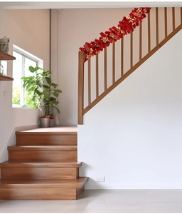 Detail of red festive garland with golden Fu characters and stars on wood stairs