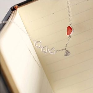 Elegant silver chain bracelet with red heart pendant and cubic zirconia heart accents