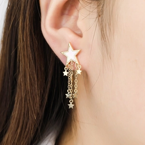 Golden star tassel earrings with white enamel center and elegant hanging star chains