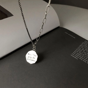 Detail of s925 silver necklace with asymmetric chain and engraved irregular pendant