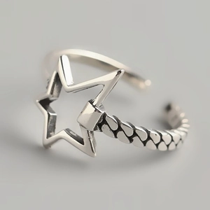 Close-up of S925 silver star ring with braided texture and adjustable open band design