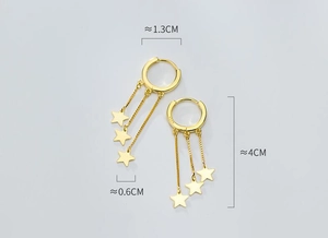 Detail view of gold S925 sterling silver hoop earrings with dangling tassel stars