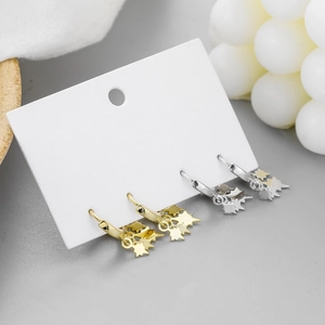 Detail of 925 sterling silver hoop earrings with star charms in gold and silver finishes