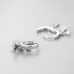 Macro view of S925 sterling silver hoop earrings with multiple hanging star charms